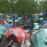Snow falls on the tents of the Occupy Wall Street protesters in Zuccotti Park.