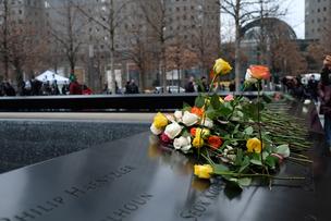 Visitors leave flowers on the names of the six victims of the 1993 World Trade Center bombing on the 25th anniversary of the attacks.