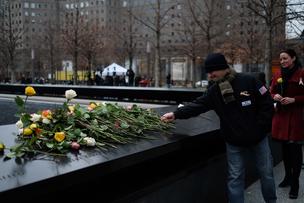 Visitors leave flowers on the names of the six victims of the 1993 World Trade Center bombing on the 25th anniversary of the attacks.