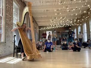  Harpist Melissa Achten performs beside Spencer Finch’s ‘Cosmic Latte’