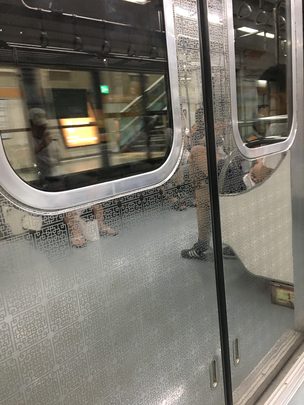 Clean, mirrored train cars in the Seoul Metro subway.