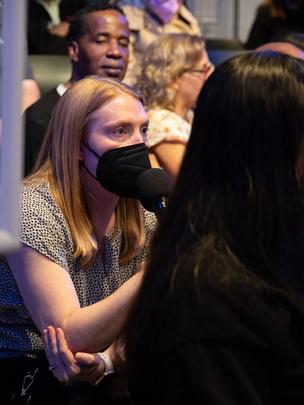 Audience member ask panelists questions during q and a session