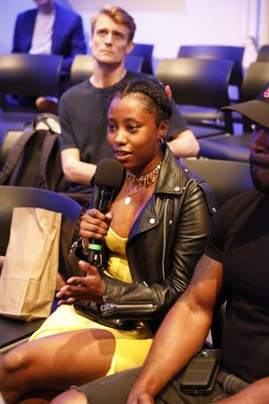 Young woman asks question during Q and  A portion of the Theater of War The Old Man performance