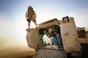 Tal Afar June 2005 - Suspected insurgents are detained inside a Bradley Fighting Vehicle to be transported to a detention facility during an early morning raid. 