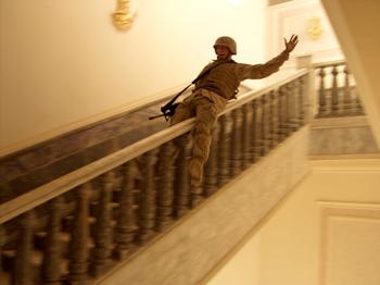 Tikrit April 14, 2003 - In Saddam Hussein’s hometown, a US Marine slides down a marble handrail in one of the dictator’s extravagant palaces. 