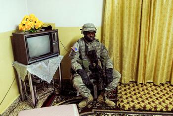 Rawah March 2006  - A weary American soldier stands guard as a residential home is searched. 