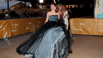 A patron arrives on the red carpet at the Metropolitan Opera's opening night