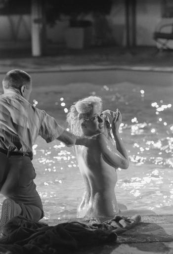 Marilyn Monroe in between set-ups at the pool at 20th Century Fox on May 23, 1962, on the movie set of “Something’s Got to Give.”  The set was a replica of director George Cukor’s home.