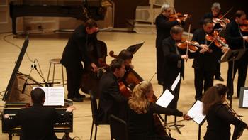 String players of Orpheus stand while playing Christopher Theofanidis's 'Muse' during the Orpheus concert Friday night.