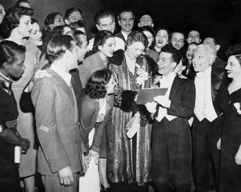 Performers look on as Al Levy, a "Pins & Needles" performer, gets the autograph of Eleanor Roosevelt following the performance at the Labor Stage, November 1945.