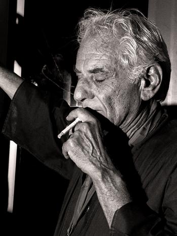 Leonard Bernstein smokes a cigarette at Avery Fisher Hall, June 24, 1988.