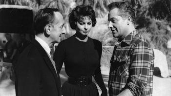 Leonard Lyons with Sophia Loren and Rossano Brazzi in Libya on the set of “Legend of the Lost.” Loren kept warm in the cold desert night by using my father’s extra pair of woolen pajamas.