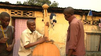 Orchestra manager Albert Nlandu Matubanza making a double bass