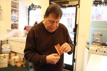 Leslie Edelman, owner of Tiny Doll House, fixes a bench.
