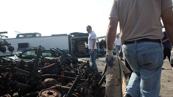 Percussionists inspecting one of the many heaps of scrap