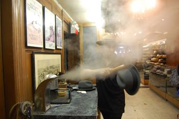 Salesman, Kevin Gerber cleans a hat with steam