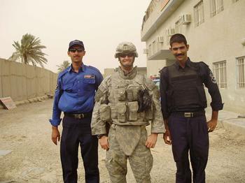 Another member of his squad also took this shot of Wilkens standing in between two Iraqi soldiers who were pushing seven feet tall.