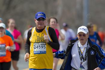 A member of the Tufts marathon team with coach Megerle