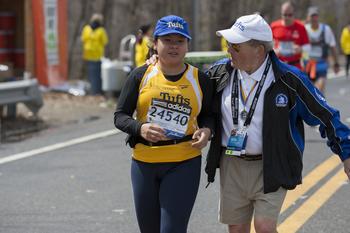 A member of the Tufts marathon team with coach Megerle