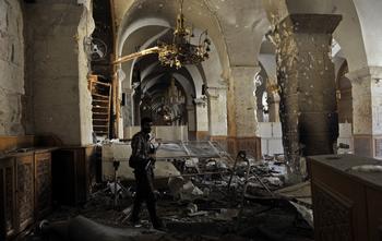 A Syrian rebel walks inside the damaged Umayyad Mosque in the old city of Aleppo hours before the Syrian army retook control of the complex on October 14, 2012.