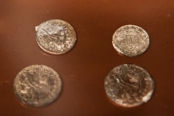 Silver and copper coins dating from 1652 to 1855, found in a 1795 time capsule, are displayed at the Museum of Fine Arts on January 6, 2015, in Boston, Massachusetts.