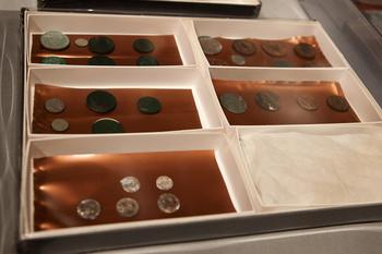 Silver and copper coins dating from 1652 to 1855, found in a 1795 time capsule, are displayed at the Museum of Fine Arts on January 6, 2015, in Boston.