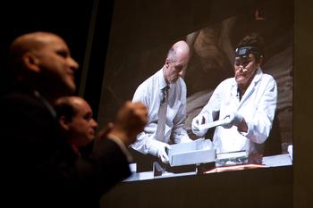 Invited guests watch as Pam Hatchfield and Michael Comeau, Director of Massachusetts Archive, unveil and examine the contents of the 1795 time capsule.