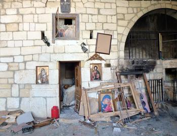 Destroyed religious icons are pictured inside a church in the ancient Christian town of Maalula on April 20, 2014.
