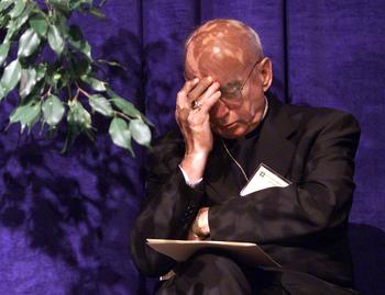 Bishop Harry J. Flynn listens as a sexual abuse victim addresses the United States Conference of Catholic Bishops opening session in Dallas, Texas. June 13, 2002