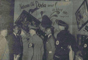 Adolf Hitler and other Nazi officials (Hoffmann, Willrich, Hansen, and Ziegler) standing by the Dada wall at the “Entartete Kunst” (Degenerate Art) exhibition, July 16, 1937. 