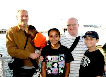 The Michener-Ives Family. David Michener (pictured left) holds their son Michael. Bill Ives stands with their children Anna and Jackson.