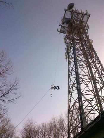 Workers hoist the new WQXW antenna up the tower.