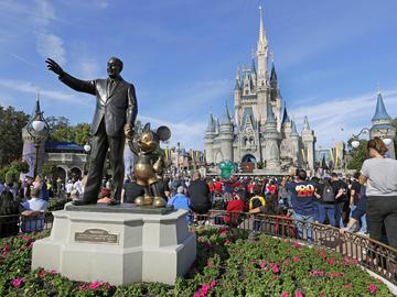 A statue of Walt Disney and Micky Mouse stands in front of the Cinderella Castle at the Magic Kingdom at Walt Disney World in Lake Buena Vista, Fla.