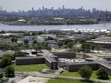  In this this June 20, 2014, file photo, the Rikers Island jail complex stands in the foreground with the New York skyline in the background. 