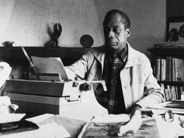 American writer James Baldwin poses in front of his typewriter in his house, March 15, 1983, Saint Paul de Vence, France.