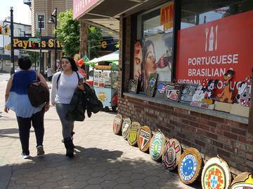 A corner with a Brazilian food cart and soccer team carvings on the street in Newark's Ironbound neighborhood.