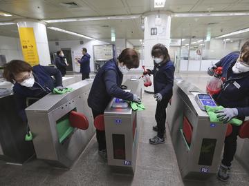Employees disinfect ticket gates in hopes to prevent the contraction of the coronavirus at a subway station in Seoul, South Korea, Tuesday, Jan. 28, 2020. 