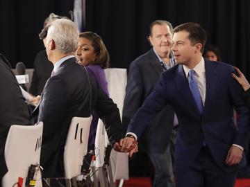 Democratic presidential candidate former South Bend Mayor Pete Buttigieg, right, reaches to greet former Chicago Mayor Rahm Emanuel, left, Friday, Feb. 7, 2020.