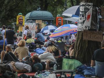 Posters of George Floyd are displayed Thursday, June 25, 2020, in New York, at an encampment of protestors outside City Hall, calling on Mayor Bill de Blasio to defund the NYPD.