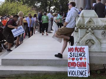 People gather Monday, Aug. 5, 2019, outside the Capitol in Hartford, Conn., where the state's political delegation and gun safety groups rallied to urge the U.S. Senate to return immediately to D.C.