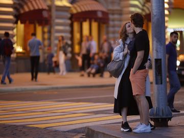 A young couple kiss during a warm evening near Red Square in Moscow, Russia, Sunday, June 14, 2020.
