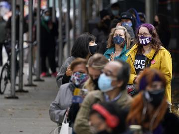 People wait in line at an early voting site in New York, Tuesday, Oct. 27, 2020. New Yorkers lined up to vote early for a fourth consecutive day Tuesday.