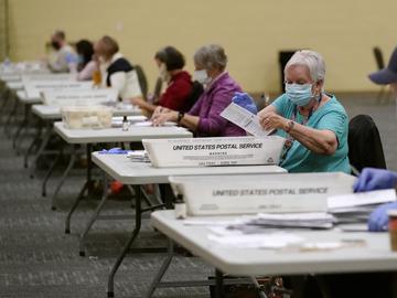 Workers prepare mail-in ballots for counting, Wednesday, Nov. 4, 2020, at the convention center in Lancaster, Pa., following Tuesday's election. 