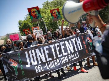 In this June 19, 2020 file photo, protesters chant as they march after a Juneteenth rally at the Brooklyn Museum, Friday, June 19, 2020, in the Brooklyn borough of New York.