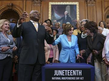 House Majority Whip James Clyburn, D-S.C., left, celebrates with Speaker of the House Nancy Pelosi and members of the Congressional Black Caucus after passage of the Juneteenth National Independence 