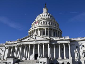 looking up at the u.s. capitol building on a cloudless day
