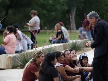 The archbishop of San Antonio, Gustavo Garcia-Siller, right, comforts families outside the Civic Center following a deadly school shooting at Robb Elementary School in Uvalde, Texas, Tuesday, May 24, 