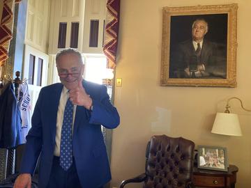 U.S. Sen. Chuck Schumer, D-N.Y., gives a thumbs-up in his office after the Senate approved Democrats' big election-year economic package, in Washington, Sunday, Aug. 7, 2022. 