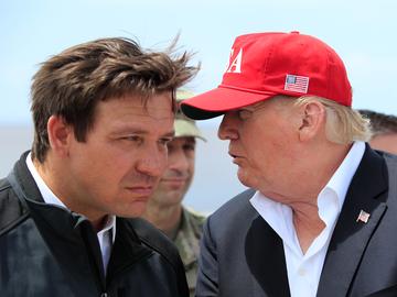 President Donald Trump talks to Florida Gov. Ron DeSantis, left, during a visit to Lake Okeechobee and Herbert Hoover Dike at Canal Point, Fla., Friday, March 29, 2019.