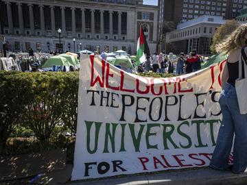 A sign is displayed in front of the tents erected at the pro-Palestinian demonstration encampment at Columbia University in New York, Monday, April 22, 2024.